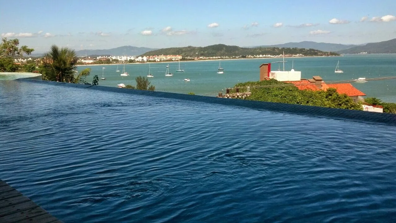 Piscina de borda infinita integrada à paisagem de Canajurê, em Florianópolis